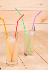 Two glasses full of lemonade.