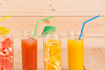 Various juices on wood table.