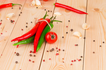 Red hot chili peppers on wood table.