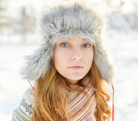 Winter portrait of young woman in fur hat