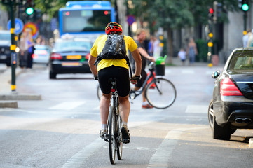 Fototapeta na wymiar Man with helmet bicycling in traffic