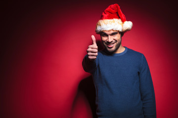 young santa showing thumbs up sign