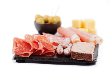 Charcuterie assortment and olives on white background