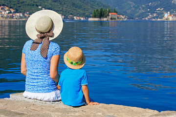 mother  and son looking at scenic view on sea vacation