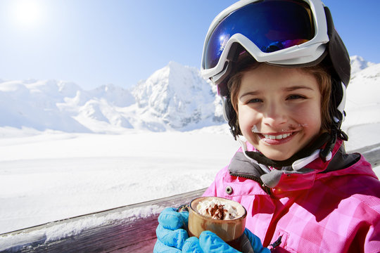 Ski, winter, child - young skier drinking hot chocolate