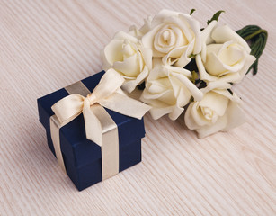 white roses and blue gift box
