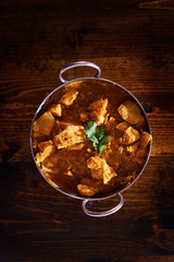 overhead photo of a batli dish with indian butter chicken curry © Joshua Resnick