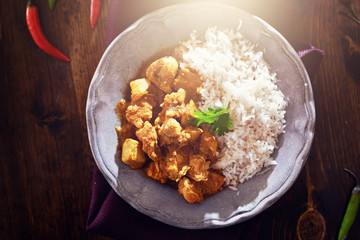 overhead view of indian chicken curry with lens flare