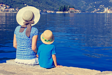 mother  and son looking at scenic view on sea vacation
