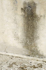 dark damp stain on old wall with cracks to be restored