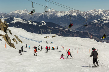 Fototapeta na wymiar Skiing people and the chair lifts of ski region in Austria 