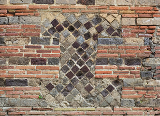 Fragment of the ancient masonry in the modern brickwall