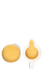 Condensed milk in tin can and milk pitcher