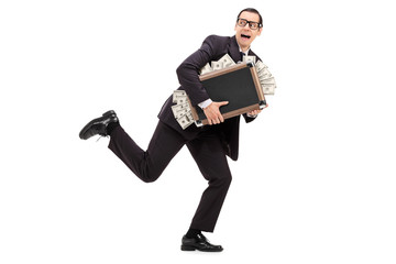 Businessman running with a bag full of money