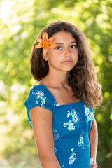 Teen girl with curly dark hair on  nature