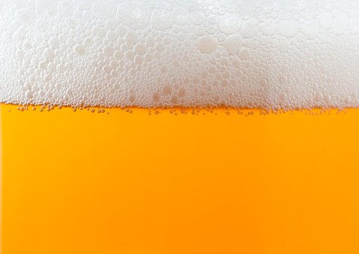 Light beer background with foam