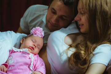 Image of young caucasian family indoor. Father, mother and cute