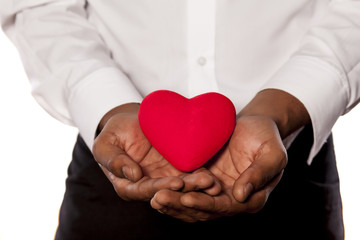 young dark-skinned man holding a heart shape object