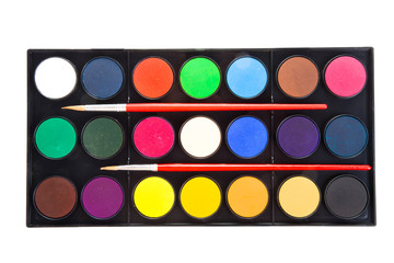 colorful watercolors paints in palette with brushes isolated on