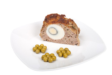 meatloaf with egg and green peas isolated on a white background