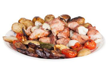 Meat with potatoes, eggplants, tomatoes, onions and peppers on t