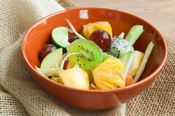 Delicious fruits salad in plate on table close-up