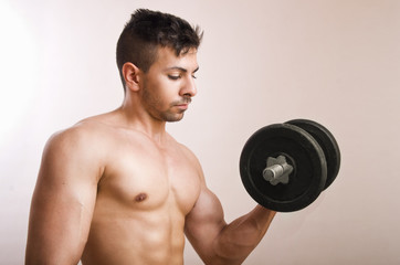 Naklejka na ściany i meble Young man lifting weights