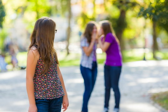 Girl looking back at her evil girlfriends