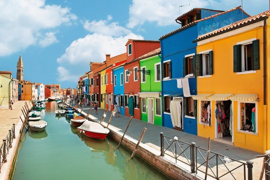 colorful houses by the water canal at the island Burano Venice