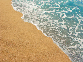 Foamy shoreline in Costa Brava beach at summer