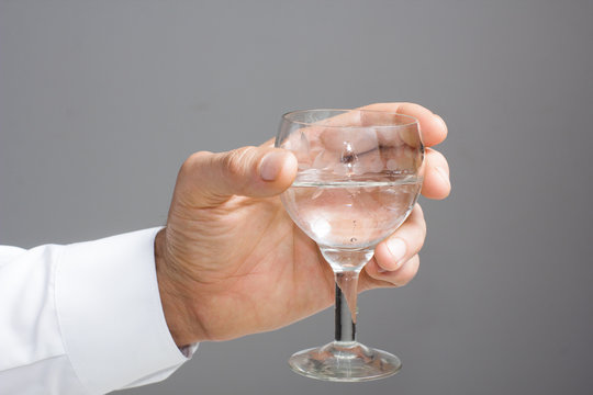 Man's hand with glass of water