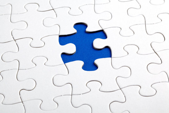 Plain white jigsaw puzzle, on Blue background