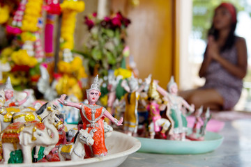Woman praying in a Hindu shrine