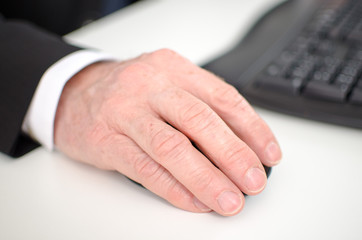 Fototapeta premium Businessman's hand holding a computer mouse