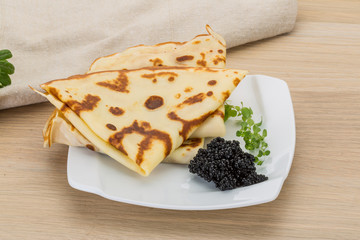 Pancakes with black caviar