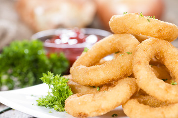 Onion Rings on wooden background