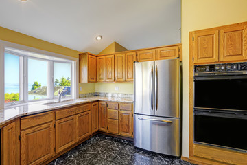 Kitchen room with granite tops and black tile floor