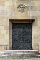 Fragment of an old cathedral facade with modern doors, Stuttgart