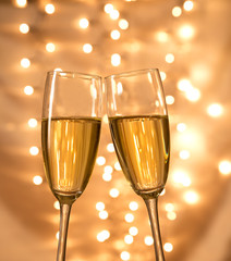 Champagne glasses on light bokeh background