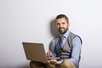 Hipster businessman with laptop