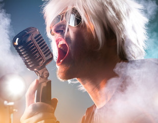 Rock singer screaming on the retro microphone