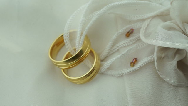 Wedding rings on ring pillow focus shift