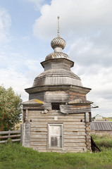 Fototapeta na wymiar Ancient wooden chapel in russian village