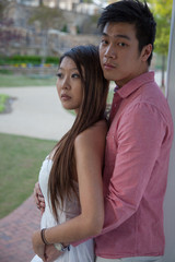 Obraz premium Asian couple hugging outdoors in a park