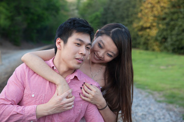 Romantic Asian couple playing outside