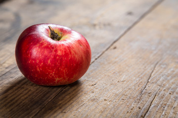 red apple on wooden background