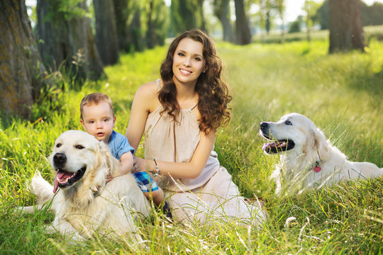Pretty mother with child and dogs