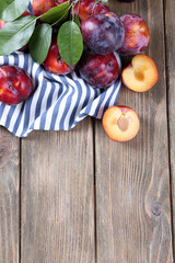 Sweet plums on wooden background