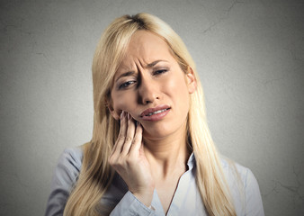 Headshot woman with sensitive tooth ache sad face expression