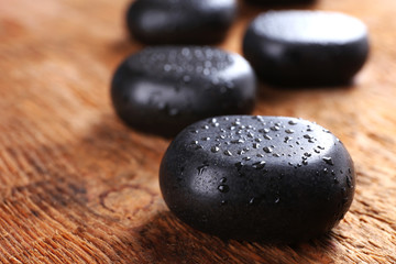 Fototapeta na wymiar Spa stones with drops on wooden background